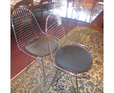 A set of four vintage wirework chairs with black leather seats