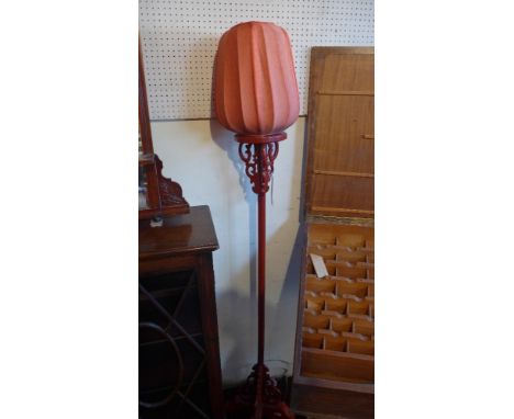 A red lacquered Chinese standard lamp with shade 