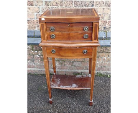 AN EDWARDIAN STYLE  MAHOGANY CANTEEN CABINET ON STANDwith serpentine front, containing a silver-plated part canteen (incomple