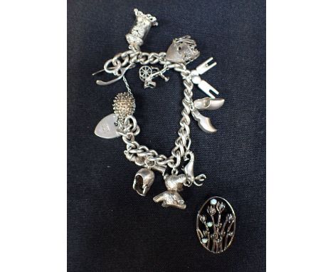 AN OPAL AND SILVER OVAL 'TULIP' BROOCHand a silver charm bracelet