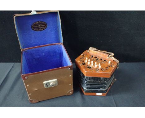 A TWENTY-ONE BUTTON CONCERTINA; ''ENGLISH MAKE'and 'TRADE MARK' and 'STEEL REEDS' stamped to grip, in a J.J. Vickers and Sons