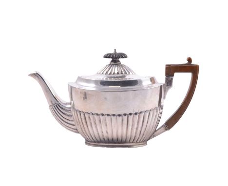 A Victorian silver bachelor's teapot, Charles Stuart Harris, London 1888, oval form, part fluted, wooden handle and finial, 1