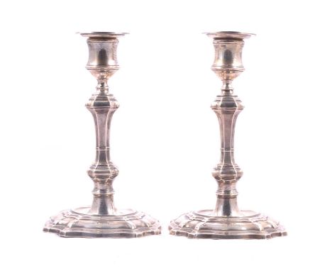 A pair of Edwardian silver table candlesticks, William Hutton &amp; Sons Ltd, London 1905, shaped and moulded octagonal bases