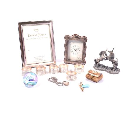 Six silver napkin rings, Tissot watch, silver locket and chain, photograph frame and clock, a plain silver Carrs photograph f