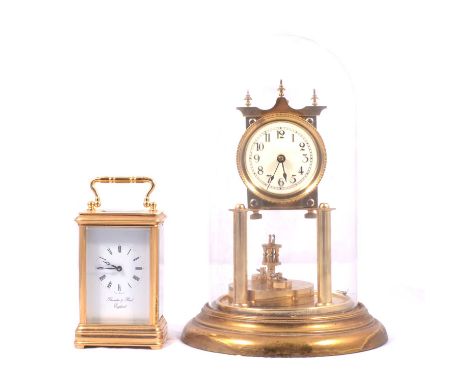 Gilt brass anniversary clock, silk suspension defective, under a glass dome, 28cm; and a modern brass cased carriage clock, t