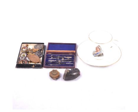 A horn snuff mull, badges, Victorian cup and saucer, the snuff mull having a metal plate to cover engraved "R Burns 1789", th