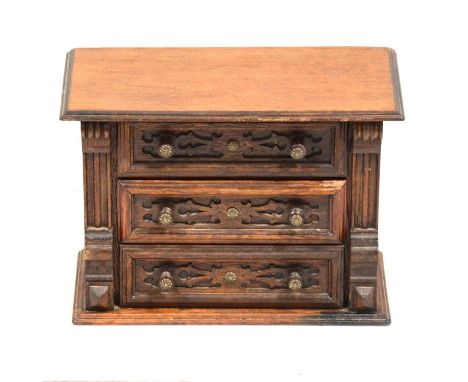 A carved oak aneroid barometer, dial signed J Long London, 87.5cm; and a carved wood table top chest of three drawers, height