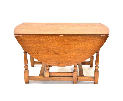 Light oak gateleg dining table, oval top, turned baluster legs, 154 x 132cm, height 76cm.