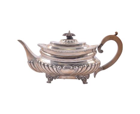 A silver three-piece teaset, Goldsmiths &amp; Silversmiths Co Ltd, London, 1899, fruitwood handle and finial, cast foliate bo