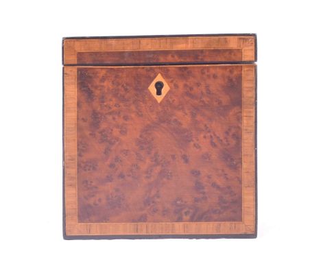 A Georgian yew wood cuboid tea caddy, crossbanded border and escutcheon, 10.5cm.Condition report:Fine cracks across all sides