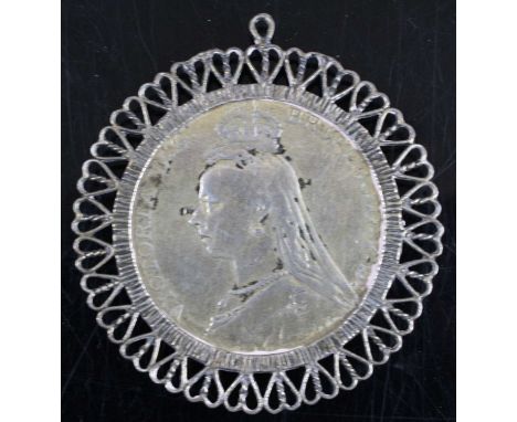 Great Britain, 1889 crown, Victoria jubilee bust, rev: St George and Dragon above date, housed in a filigree work pendant mou