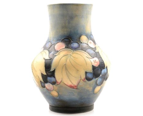 A William Moorcroft salt glazed vase in the Leaf and Berries design, signed on base, dark blue berries and green leaves on a 