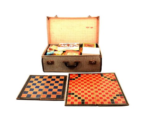 A vintage suitcase containing vintage games and various playing card games, Television Puzzle; Canasta; Shake Words; R J Puzz