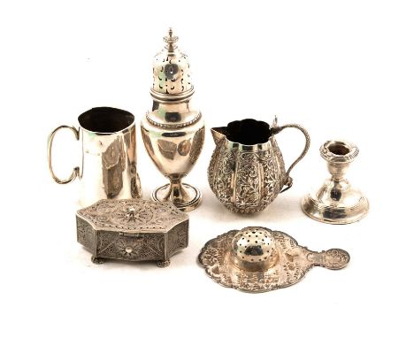 A silver sugar caster, marks rubbed; a squat silver candlestick with filled base; small silver christening mug, marks rubbed,