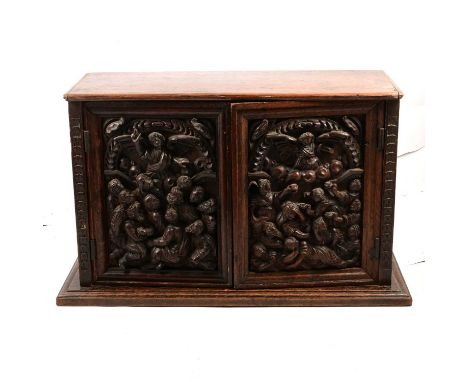 Victorian carved oak small cupboard, the cupobards carved in heavy relief with religious figural scenes, width 57cm, depth 22