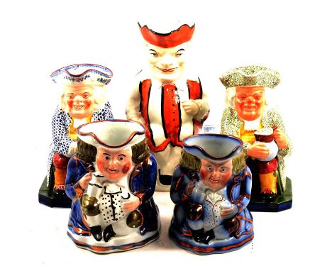 Five assorted early 20th century Toby jugs including a seated Mr Punch, orange and white striped costume, 25cm, two Copeland 