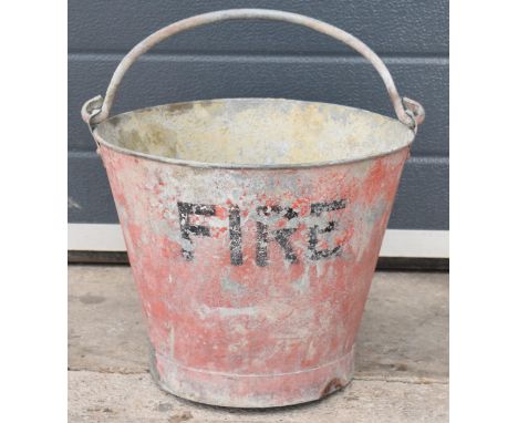 Vintage metal fire bucket with swing-over handle painted red with 'FIRE' in black, 28cm tall with handle down.  