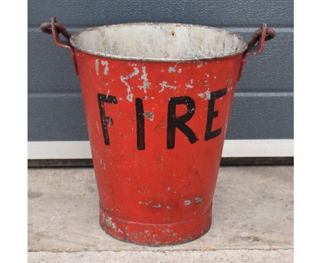 Vintage metal fire bucket with swing-over handle painted red with 'FIRE' in black, 33cm tall with handle down.  