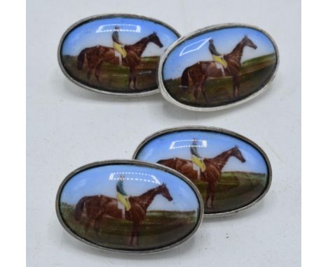 A pair of silver and enamel cufflinks decorated with jockeys (2).  