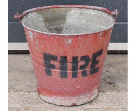 Vintage metal fire bucket with swing-over handle painted red with 'FIRE' in black, 29cm tall with handle down.  