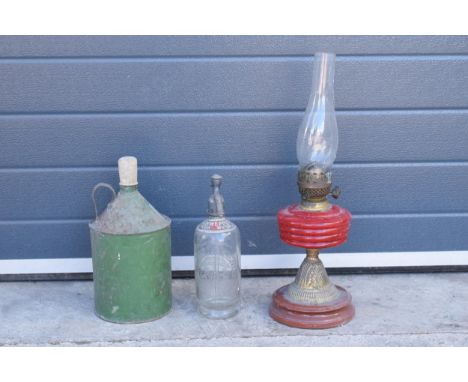 Early to mid 20th century brass oil lamp with red glass reservoir together with a vintage fuel can and Soda Water bottle (3).