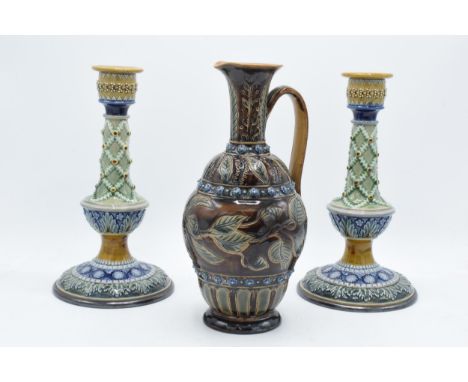 A pair of Doulton Lambeth candlesticks, circa 1880, with artist's monograms to base to include Bessie Newbury, E Wakley etc, 