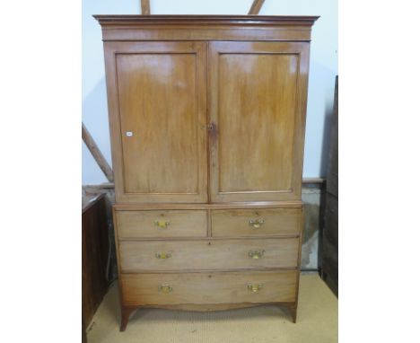 A Regency mahogany linen press, a pair of panelled doors above two short and two long drawers on splayed bracket feet - Heigh
