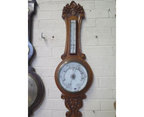 A 1930's oak barometer with a thermometer over the dial