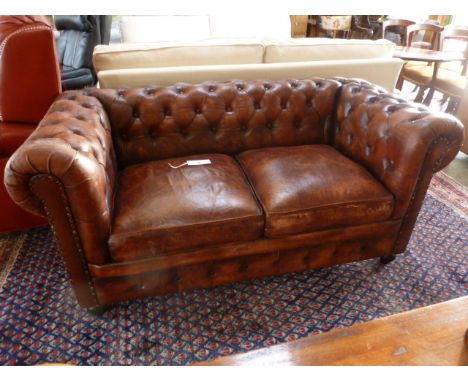 A modern leather Victorian style Chesterfield button back two seater sofa- distressed condition with no major damage- W 157cm