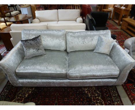 A designer crushed velvet three seater sofa