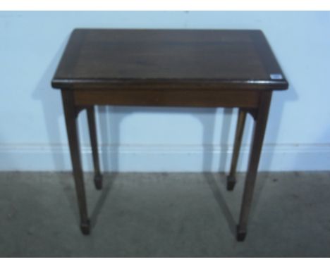 An early 20th century mahogany card table with green base fold over and swivel top raised on square tapering supports - 69cm 