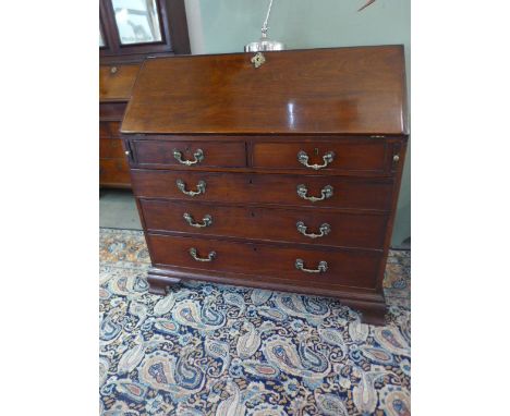 A good quality Georgian mahogany bureau with a fall front and fitted interior of drawers and pigeon holes, over two short and