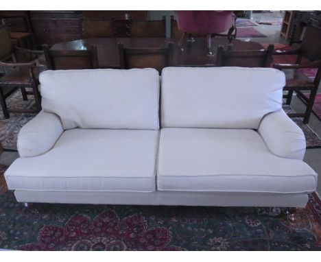 A modern three seater sofa - Length 200cm - on turned legs and brass casters