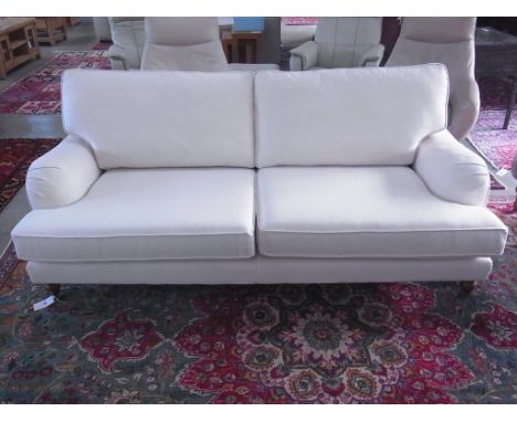 A modern three seater sofa - Length 200cm - on turned legs and brass casters