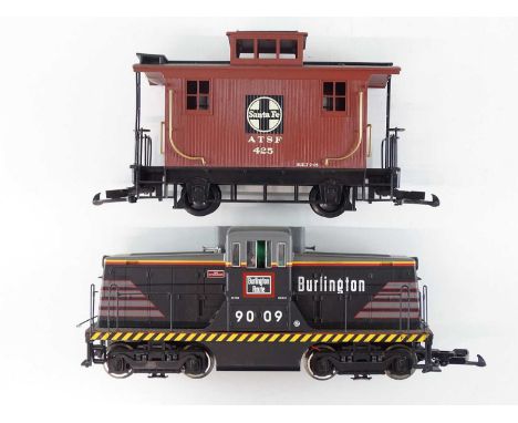 A USA TRAINS G scale Burlington 44 ton switcher diesel locomotive, together with a BACHMANN Big Haulers Santa Fe caboose - G/