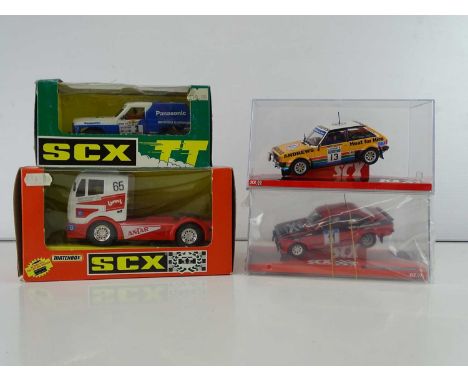 A group of 1:32 scale slot racing vehicles by SCX comprising 2 x  Rally cars, a Nissan Patrol and a Mercedes Truck - VG/E in 