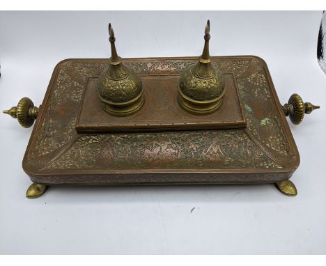 A 19th century Islamic brass and copper desk inkwell, stylised detail of flora and fauna and figural studies with serpents, t