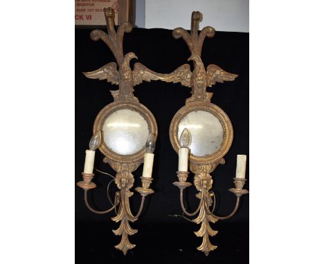 A PAIR OF GILDED TWO LIGHT GIRANDOLES  the convex mirrors with eagle surmounts, 100cm high overall Condition Report : very du