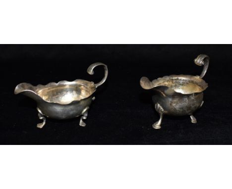 TWO GEORGIAN SILVER SMALL SAUCEBOATS  of traditional form on three paw feet with scroll boarder, Hallmarks rubbed to both, ea