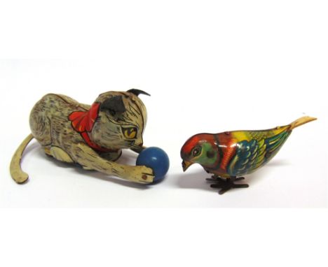 TWO TINPLATE TOYS  comprising a Fairylite pecking bird, 9.25cm long; and a Marx (Great Britain) cat with a ball, 13.5cm long.