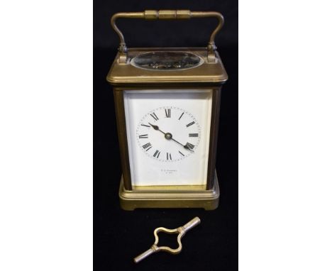 A BRASS CARRIAGE CLOCK the enamel dial with Roman numerals, inscribed 'T R RUSSELL P*RIS', 15cm high