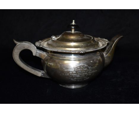 A LARGE SILVER PRESENTATION TEAPOT The melon shaped teapot with gadroon border, hardwood handle and knop engraved inscription