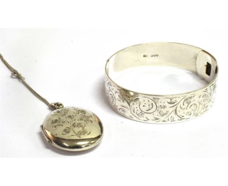 A SILVER HINGED BANGLE  by Charles Horner of traditional belt form, scroll engraved, hinged with hook fastener, Chester hallm