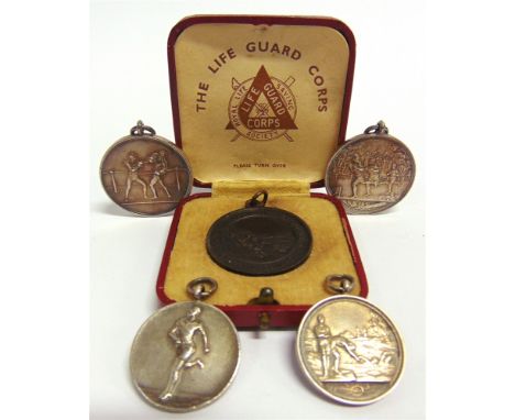 FOUR SILVER SPORTING MEDALS  for athletics (1), swimming (1) and boxing (1), each unengraved verso; together with a Royal Lif