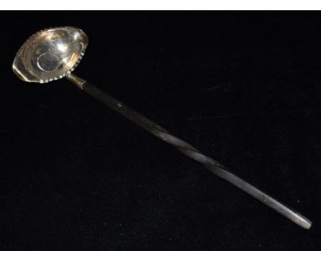 A GEORGIAN SILVER TODDY LADLE With coin bottom and whale bone twist handle with oval bowl and double pouring lip crimped boar