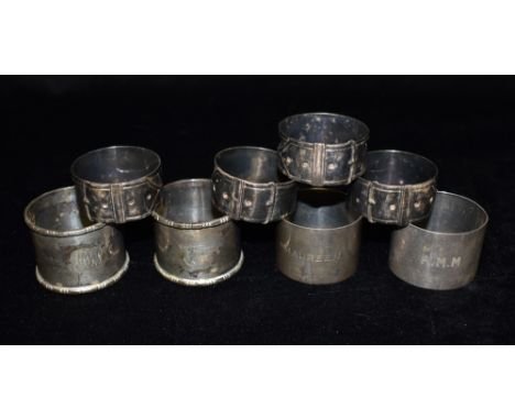 FOUR SILVER NAPKIN RINGS Two pairs of each total weight approx. 5.2 ozt (164 grams) together with a four white metal belt des