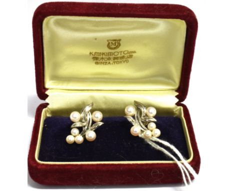 A MIKIMOTO BOXED PAIR OF PEARL AND SILVER SCREW BACK EARRINGS Each comprising 6 Mikimoto cultured pearls stamped silver with 
