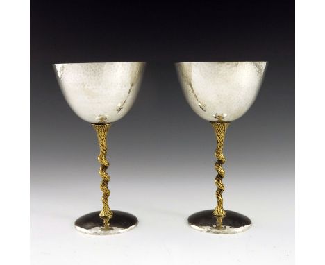 Stuart Devlin, a pair of Modernist silver and parcel gilt goblets, London 1973, planished rounded bowls on barley twisted bar