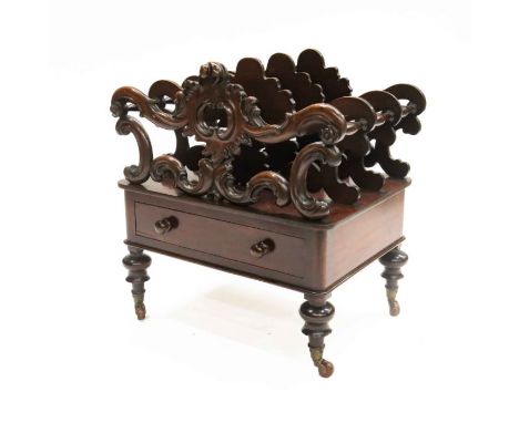 A mid Victorian rosewood canterbury, circa 1860, triple scroll divisions, single frieze drawer below, baluster legs, ceramic 