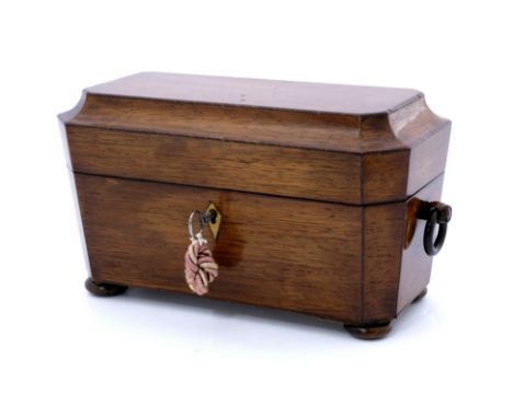 A Regency rosewood tea caddy, circa 1820, strung and of sarcophagus from with ring side handles and bun feet, the red morocco